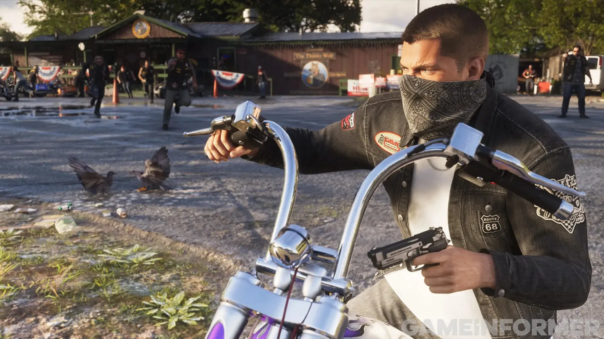 A biker with a bandana over his face aims a pistol from his chopper outside a roadside bar as other bikers run toward him.