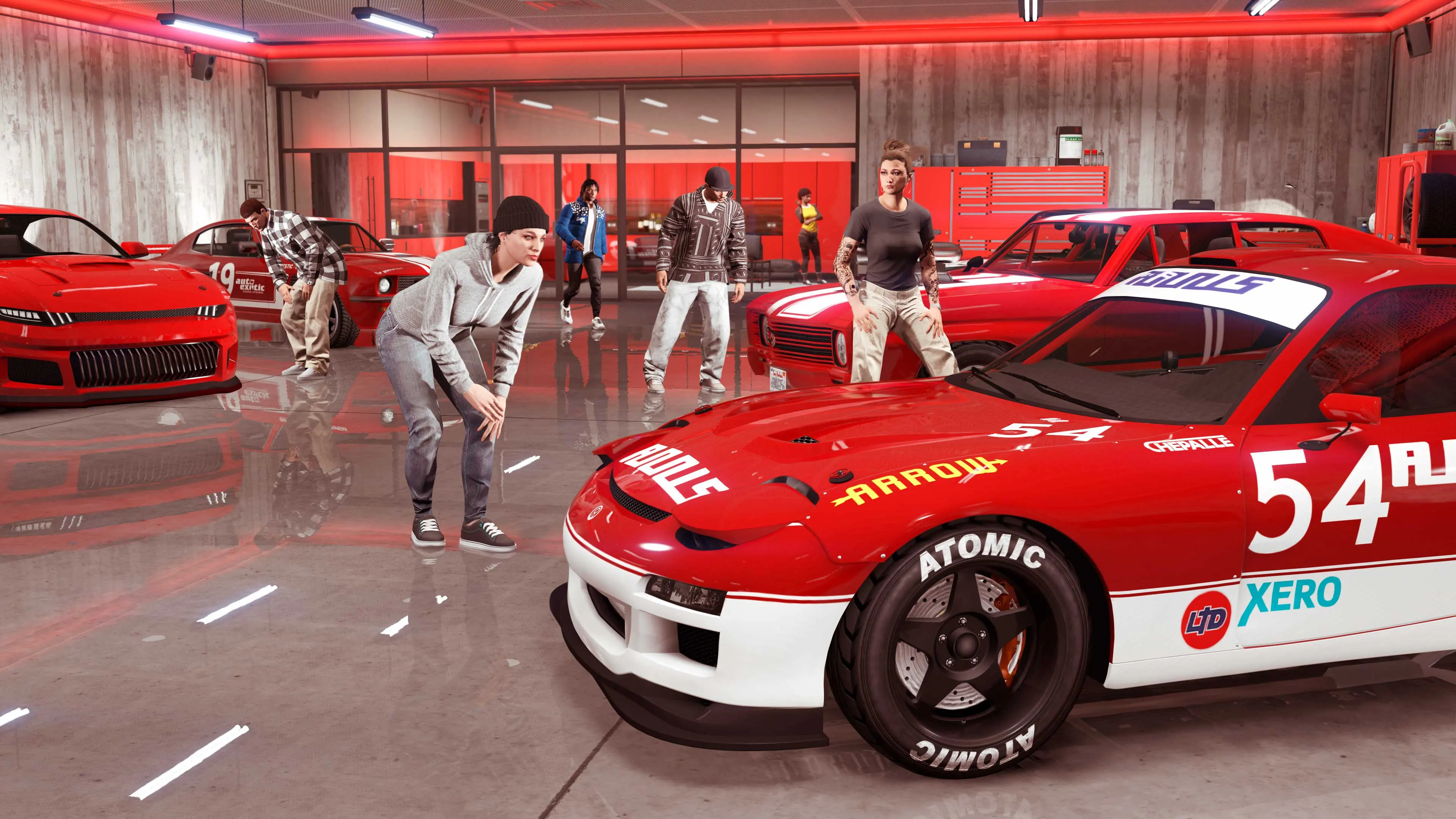 Several GTA Online characters on a red-themed floor of the Eclipse Blvd Garage, beside a red and white race car numbered 54.