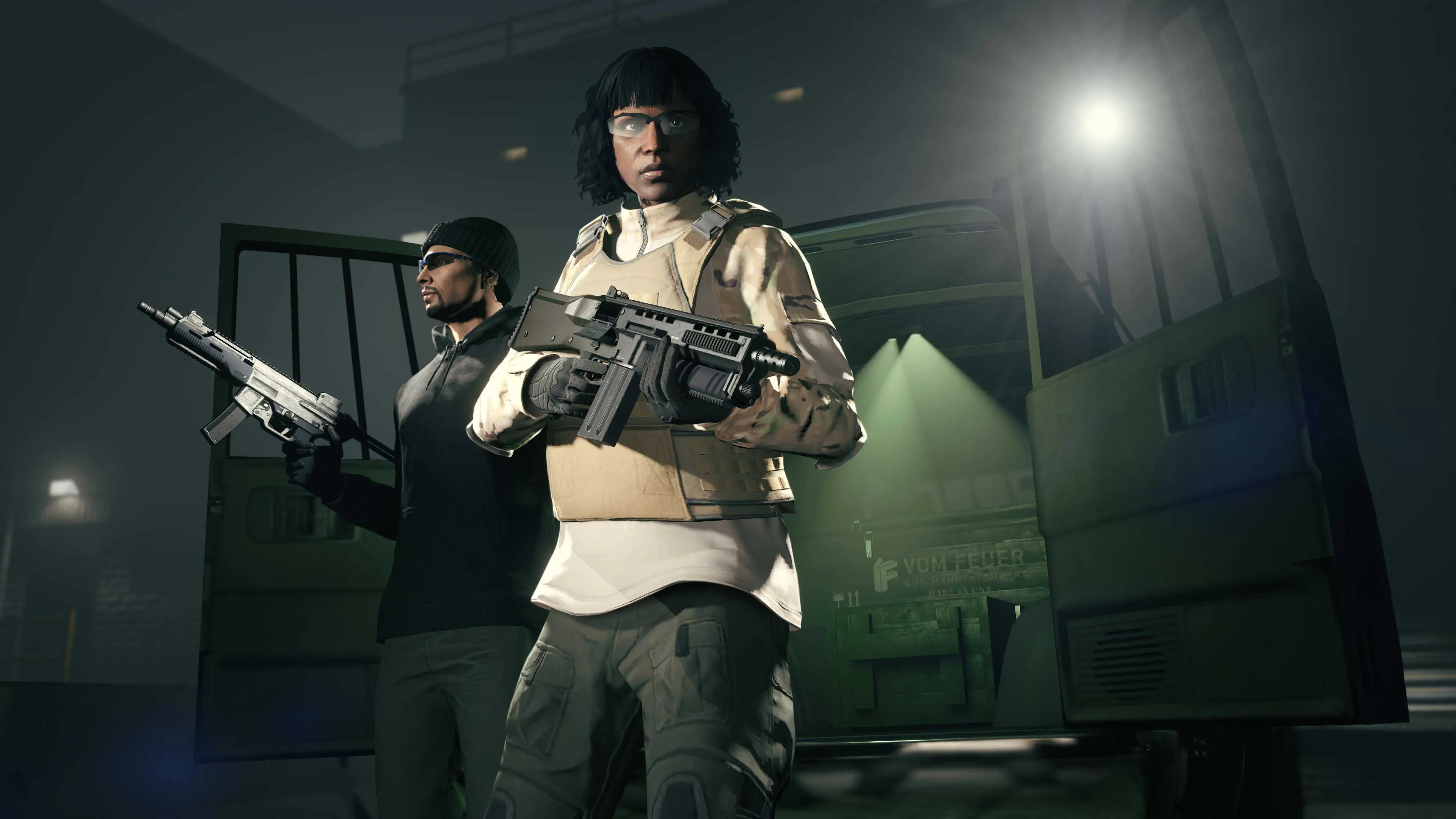 Two armed GTA Online characters beside the open rear doors of the Gun Van at night.